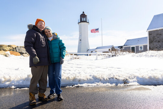 Looking at camera lighthouse Senior couple  Portrait 