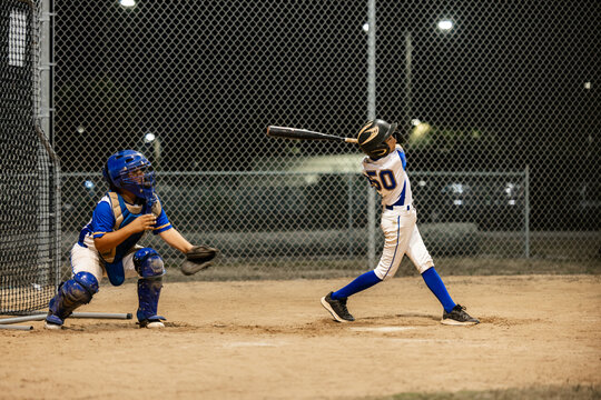Young Baseball Players Practice at Night on the Diamond