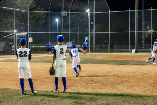 Young Baseball Team Trains in Night Practice Session