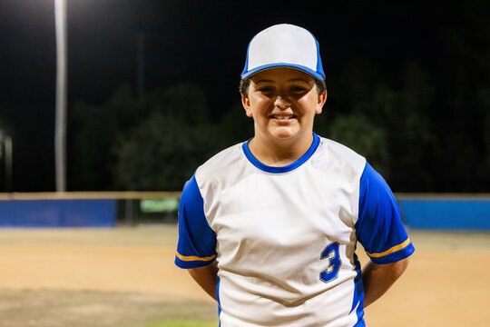 Youth Baseball Player Poses for Portrait at Night