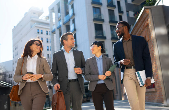 Group of business people walking in city street