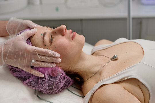 Woman prepared for facial injections in cosmetic clinic