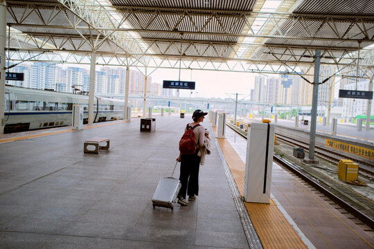 Traveling in China at a Busy Train Station With Luggage