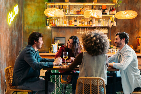 Friends enjoying dinner and drinks at restaurant bar