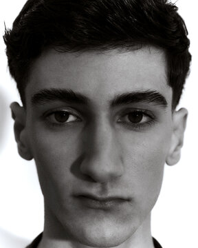 Black and white portrait of young man looking at camera