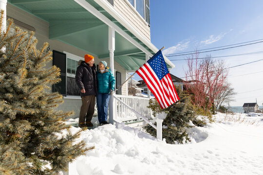 Portrait senior Couple American Flag porch house