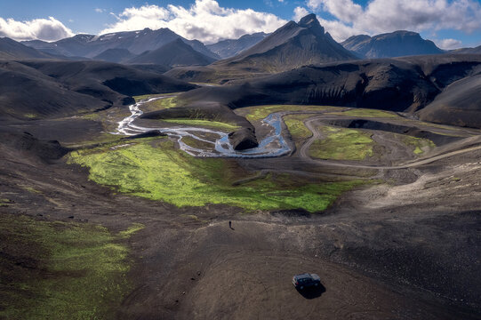 Person and 4WD dwarfed by volcanic plain, F208 Iceland