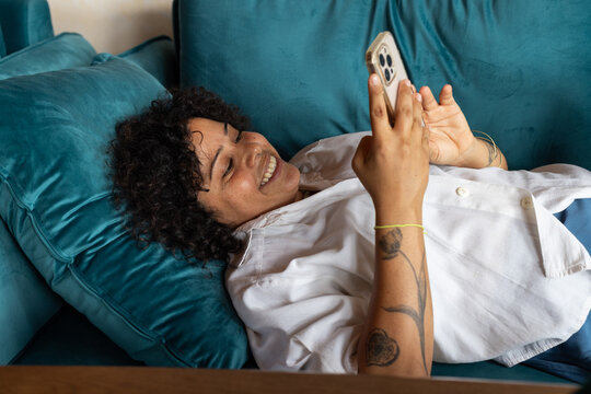 good news, woman smiling looking at the screen of mobile phone
