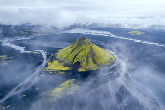 M&aelig;lifell volcano wrapped in mist above glacial plain, Iceland