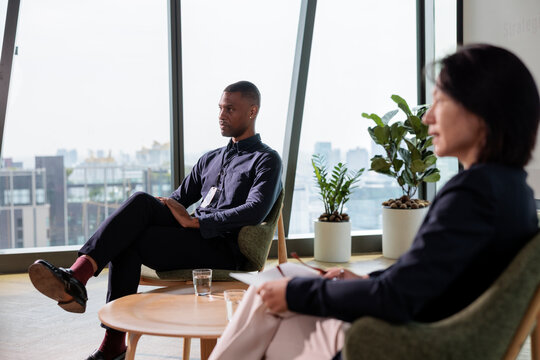 Business meeting in a modern office with city view.