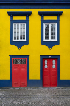 Yellow Facade with Blue Windows and Red Doors