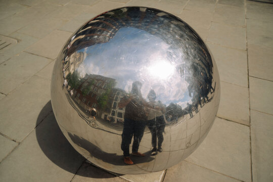 Reflection of couple on mirror ball in front of St Paul's Cathedral 