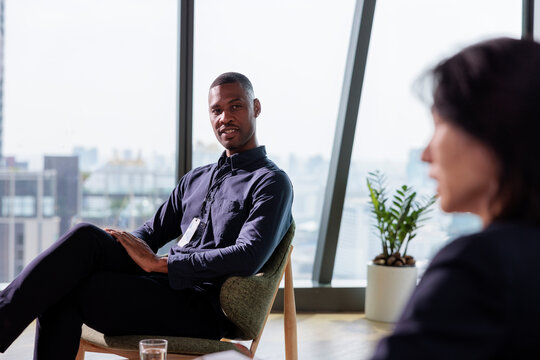 Man in meeting with city view background.