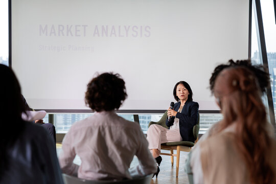 Speaker presents market analysis to audience.