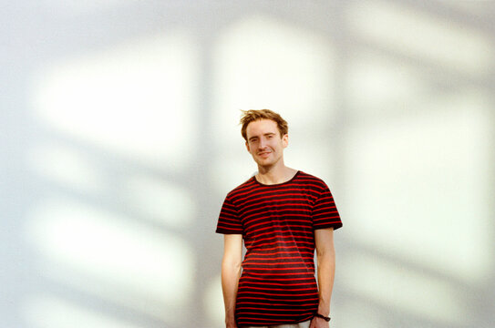 Smiling man in striped shirt in sunlight