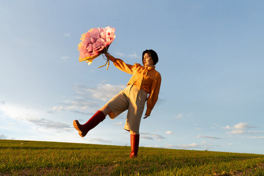 Bright spring day with flowers and casual outfit on a green field