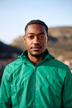 Portrait of young black adult looking at the camera outside