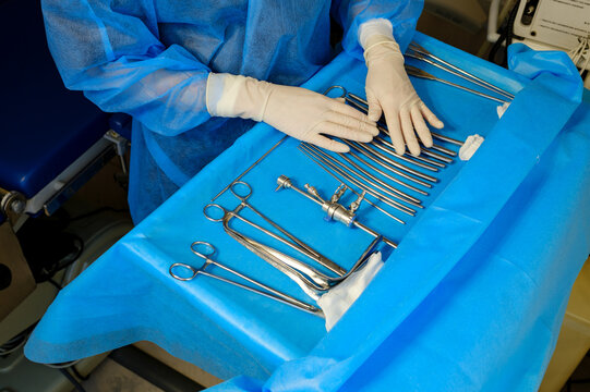 a doctor's hands with instruments in an operating room