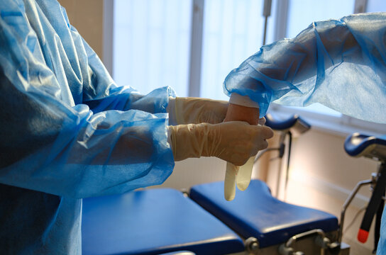 A portrait of a doctor and a trainee wearing sterile gloves