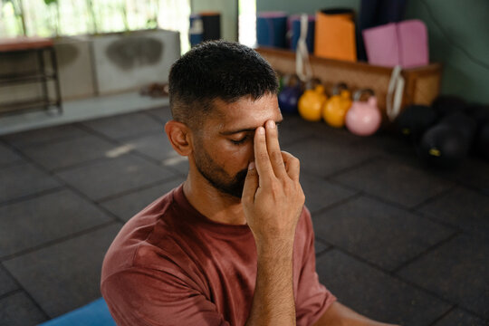 Man Practicing Breath Control in a Gym Setting