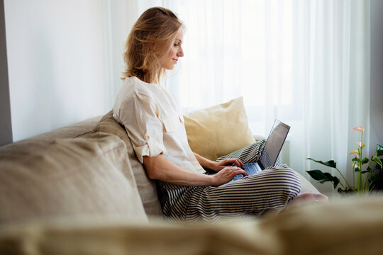 Woman Working Remotely On Laptop At Home
