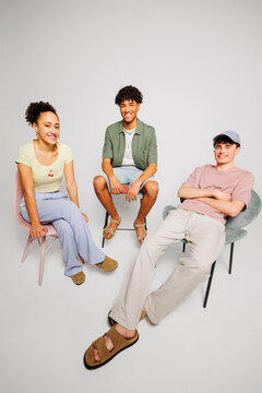 Friends sitting smiling together on chairs