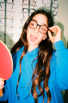 Playful girl trying glasses