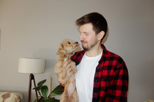 A young man hugs his dog