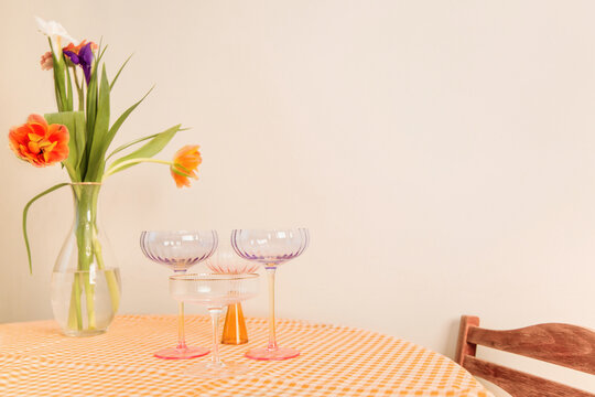 Dinner table set with flowers and wineglasses for gathering 