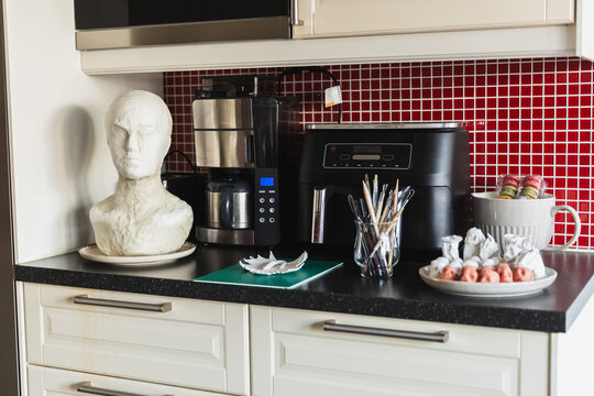 Kitchen interior with a handmade clay sculpture on the counter
