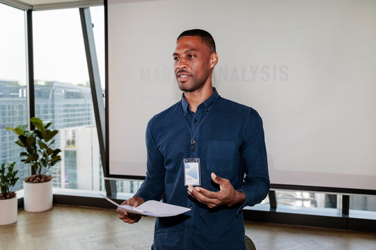 Speaker presents market analysis in modern office setting.