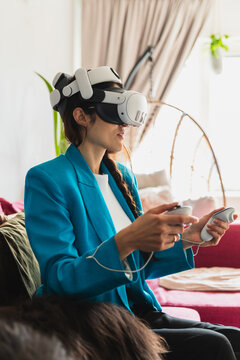 Female player sitting on a couch and enjoying virtual reality