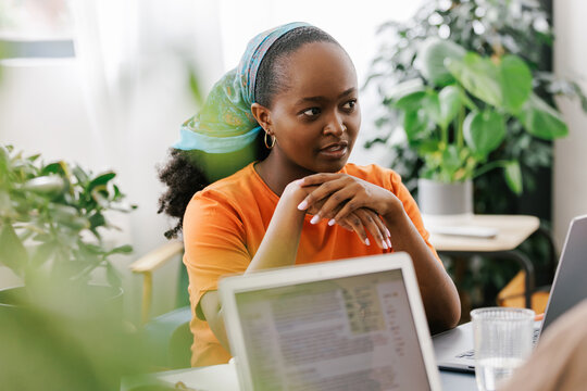 Young black woman at a business meeting talking with colleagues 