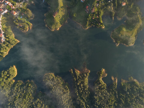 Guatape el penol reservoir aerial view with morning fog