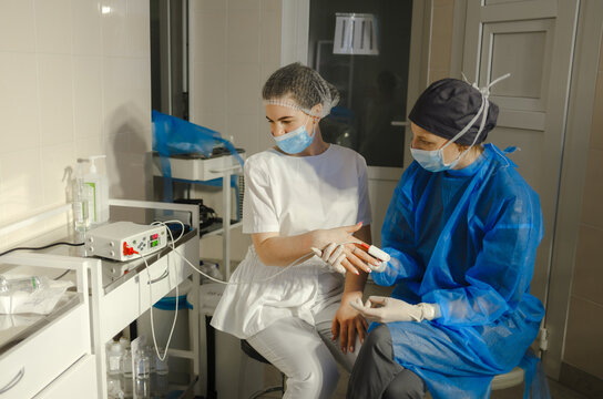 A doctor measures a trainee's blood pressure