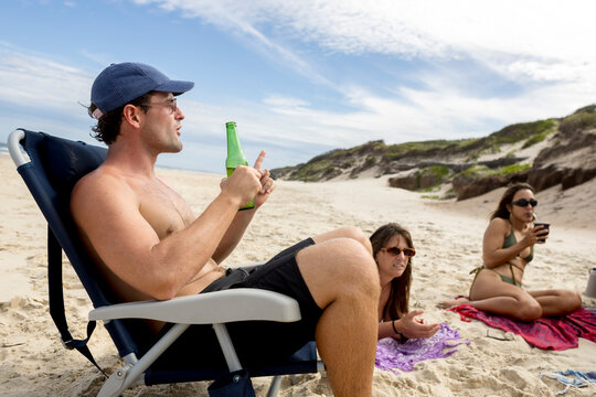 ugc Mixed adult Friends talking on beach in Australia