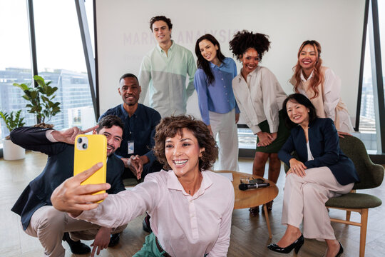 Diverse team takes a selfie after a market analysis presentation.