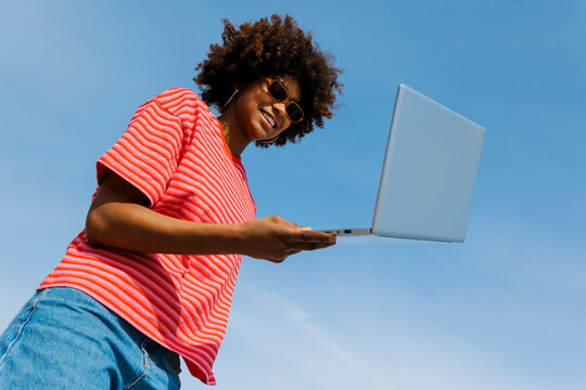 Person enjoying digital nomad lifestyle with laptop outdoors