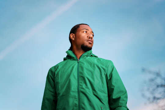 Portrait of young black adult looking at the camera outside