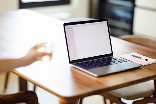 Laptop on Wooden Table in Home Workspace