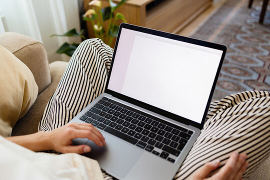 Person Working on Laptop at Home on Couch