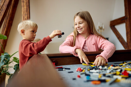 Children Build and Play With Toys Inside a House