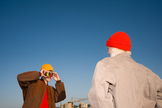 Couple Take Photos Using Disposable Camera Outdoors