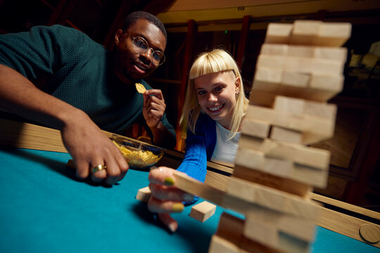 Woman pulls out jenga tile