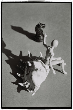 Figure riding a shell with a chess piece in the background