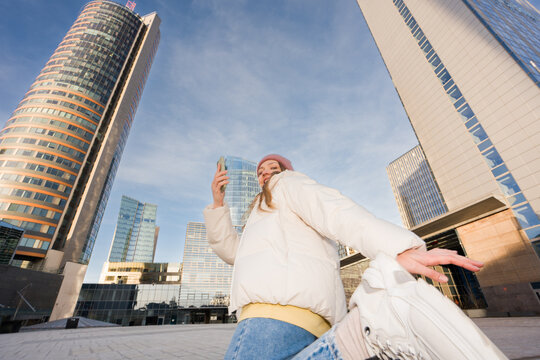 Woman Holding Cellphone And Dancing in the City
