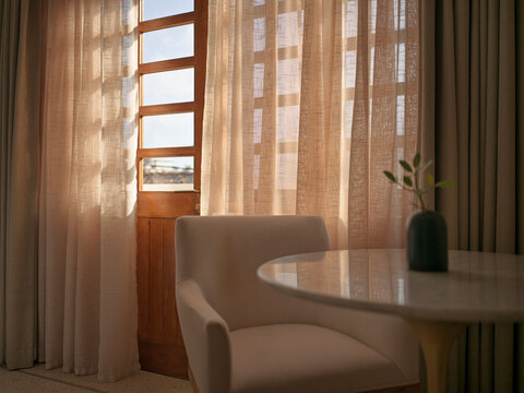 Bright Room With Sunlight and Open Door in a Simple Setting