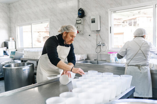 Artisan cheesemakers crafting traditional dairy products