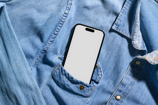Smartphone in a denim shirt pocket