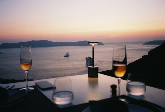 Film Photo of Wine Glasses at Sunset Dinner Table, Santorini